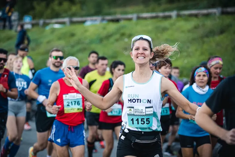 Runner in a RunMotion jersey at the start of a race