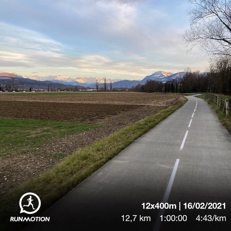 Runner on a flat road in Chambéry, starting point for scenic trail routes and mountain views.