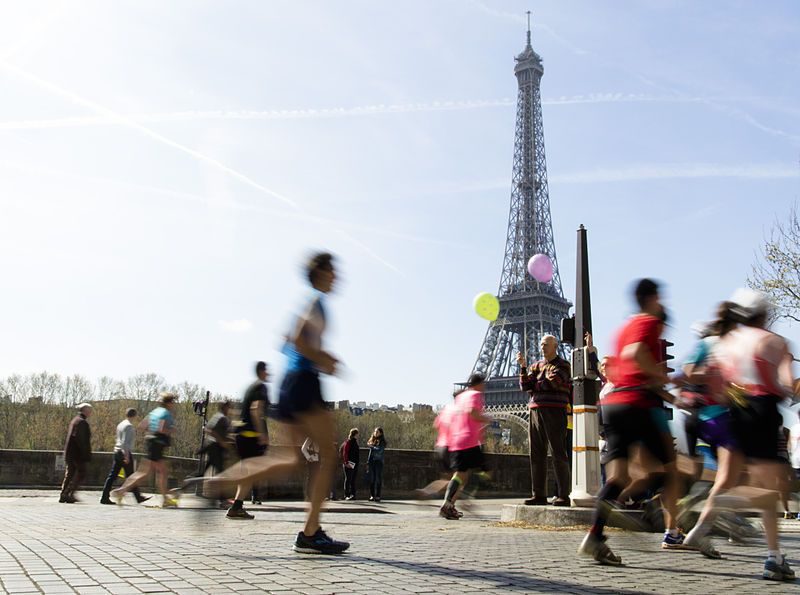 Runner training on scenic Paris route with Eiffel Tower views, ideal for endurance running workouts.