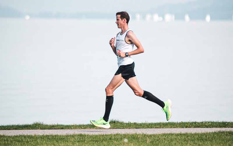 Runner training smarter to prevent running injuries, focusing on balanced workouts and recovery habits.