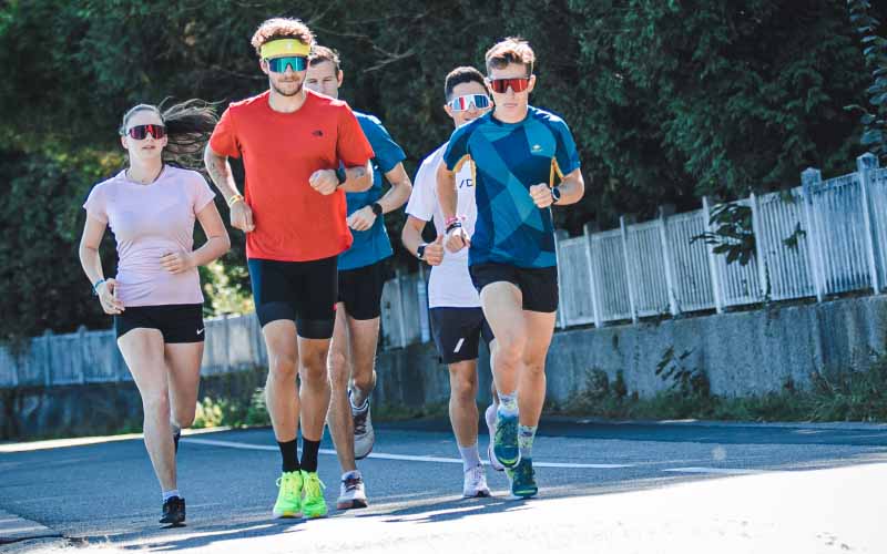 Runner stretching after training, showing smart training and recovery tips to prevent running injuries.