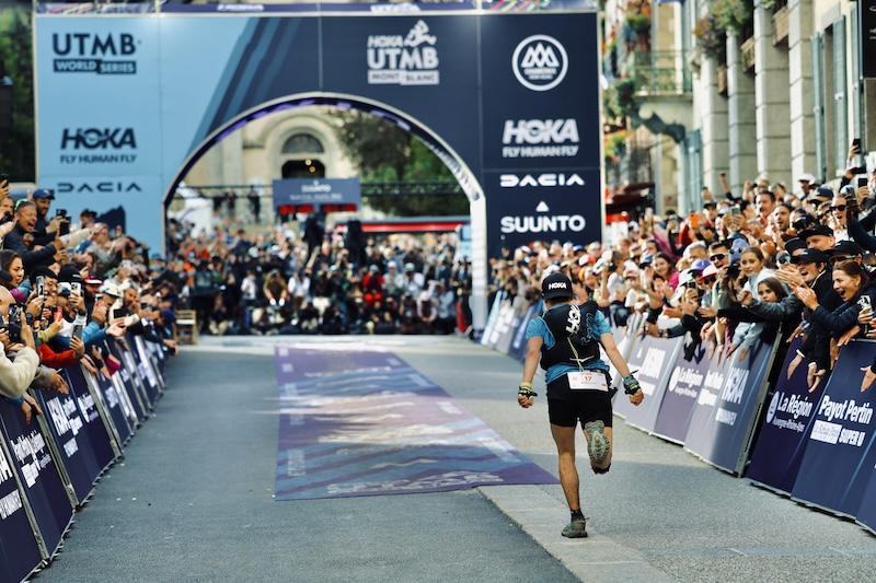 Trail runners racing at UTMB, highlighting fastest record times, most wins, and legendary champions.