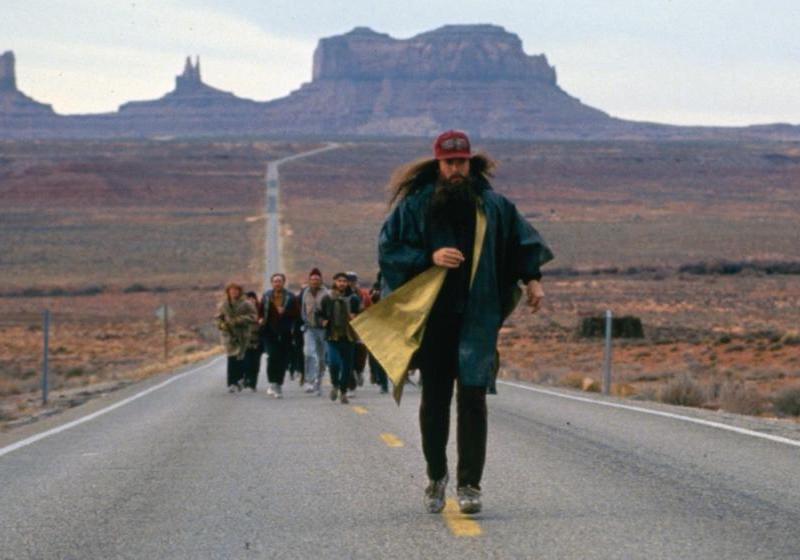 Forrest Gump running across America, illustrating ultra-endurance distance, steady pace, and mental resilience.