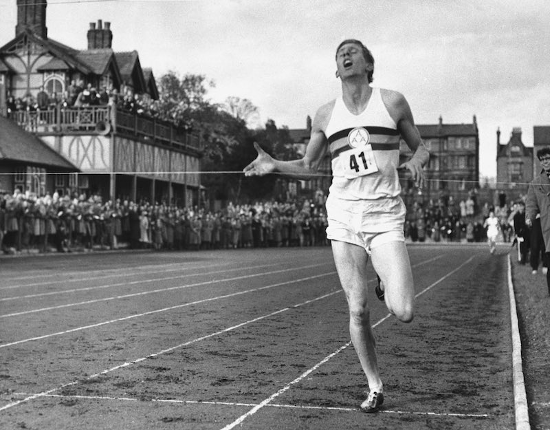 Runner breaking the four-minute mile barrier on track, inspired by Bannister’s historic breakthrough.