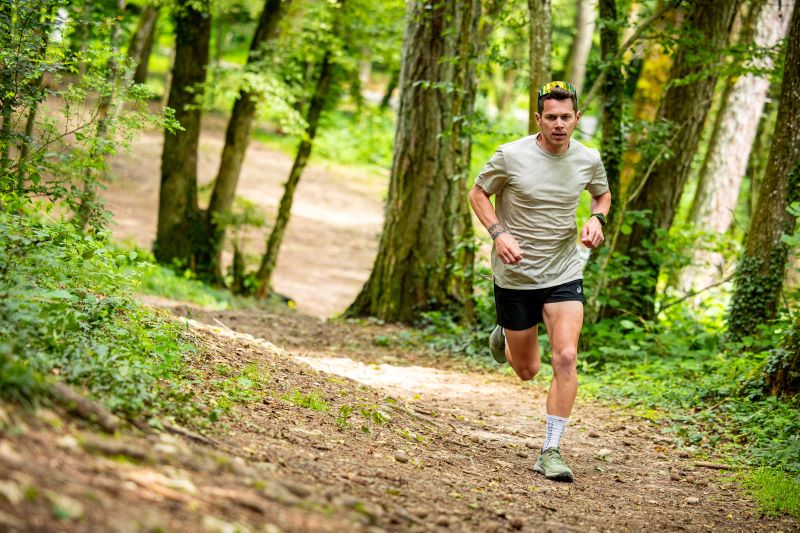 Trail runner doing hill repeat workout on steep climb to improve trail running climbing strength.