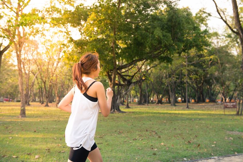 Runner training on a road, illustrating the real truth about running health benefits and injury risk.