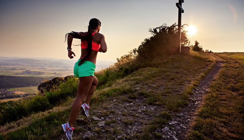 Trail runners climbing steep alpine terrain in a tough mountain ultra-trail race like UTMB.