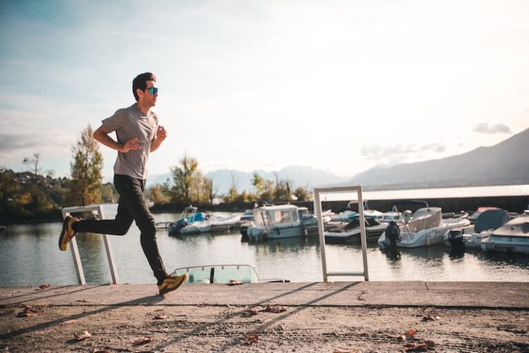 Man running by the lake to lose weight