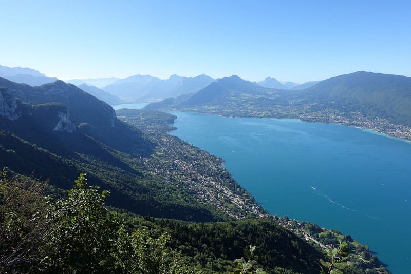 Trail runner on Annecy route climbing Mont Veyrier and Mont Baron above the lakefront.