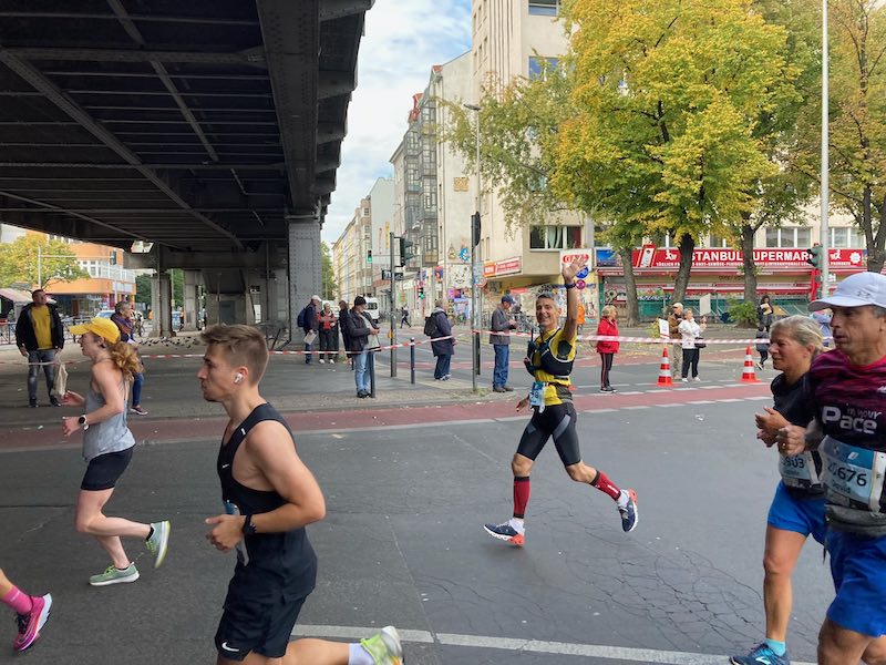 Runner finishing the Berlin Marathon in 3:52, highlighting endurance training secrets and race strategy.