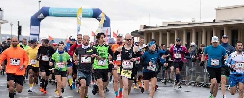 Runners at the Deauville International Marathon along France’s Normandy coast during a scenic fall race.