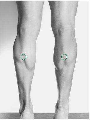 Runner using foam roller and shiatsu self-massage techniques to recover faster after a long run.
