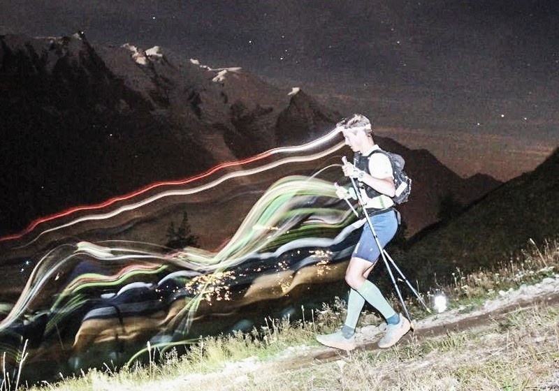 Night trail runner training with headlamp, improving sleep and race performance on rugged trails.