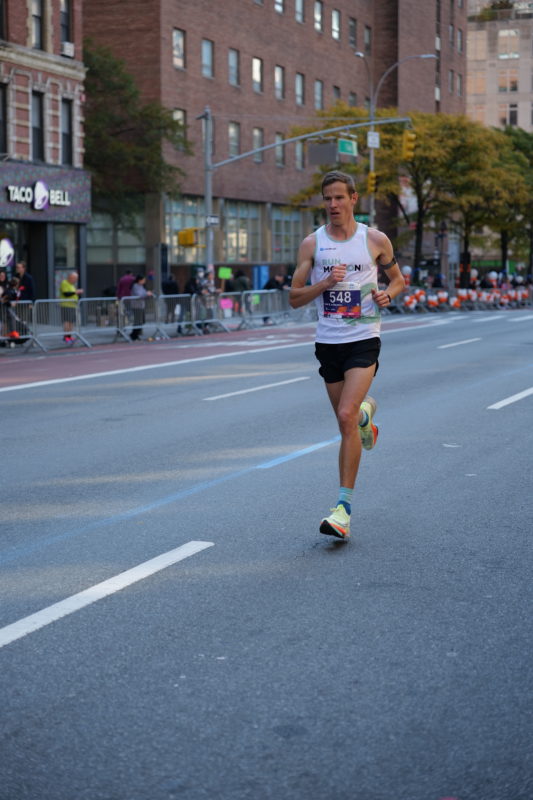 Race-day photos of runners at the NYC Marathon 2023, featuring RunMotion Coach coverage.