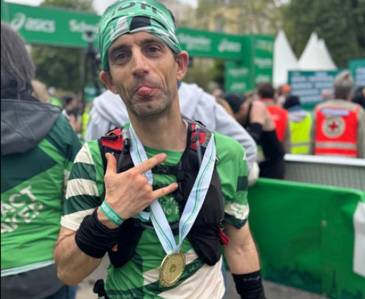 Runner at Paris Marathon 2025 breaking 3:30 despite ankylosing spondylitis, celebrating strong finish.