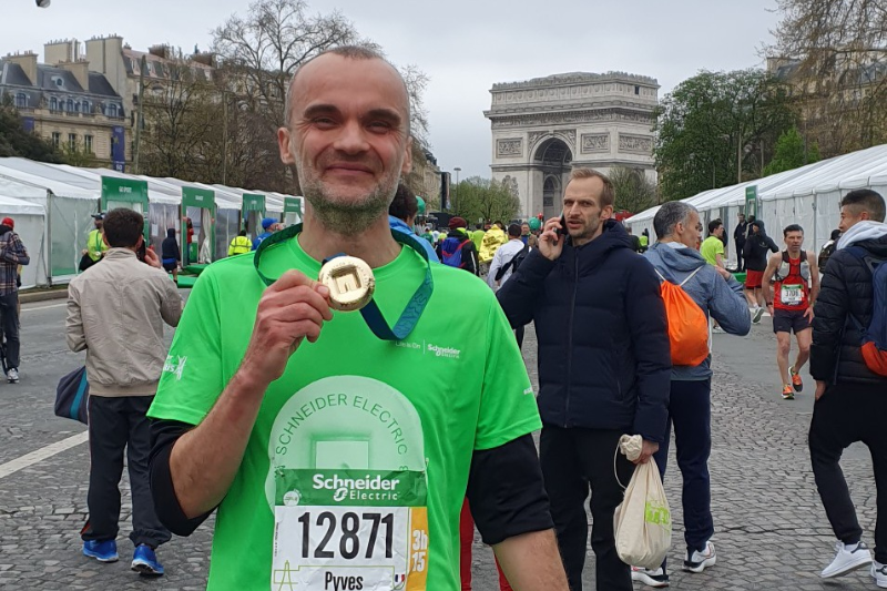 Runner Pierre-Yves celebrating a Paris Marathon personal best after increasing training from two weekly runs.