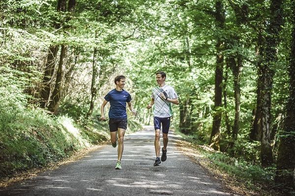 Runner on a scenic road starting today to boost endurance with consistent training benefits.