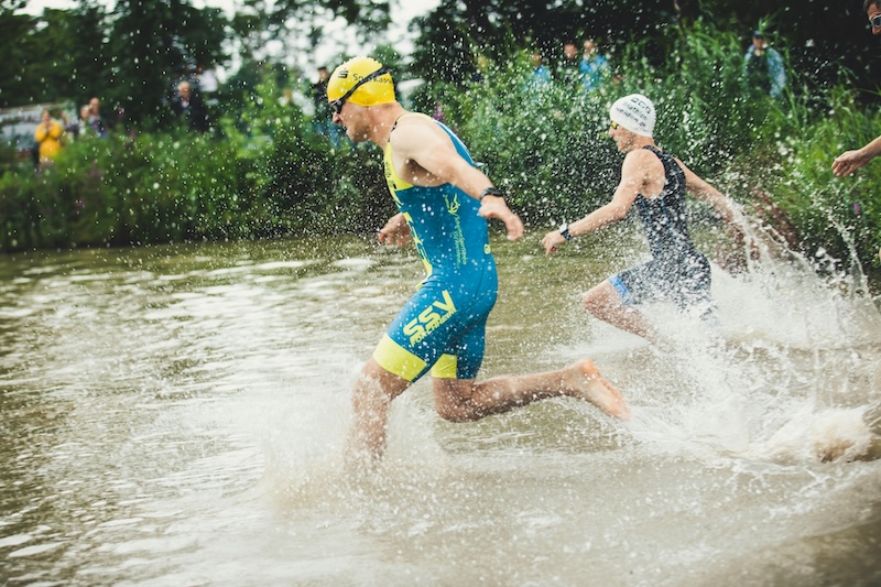 Triathlete eating balanced pre-race meal for optimal triathlon fueling and peak performance.