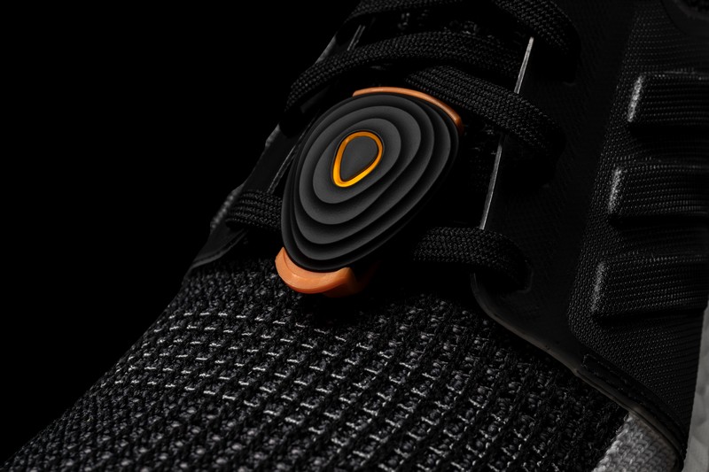 Runner using Stryd running power meter with GPS watch for smarter endurance training insights.