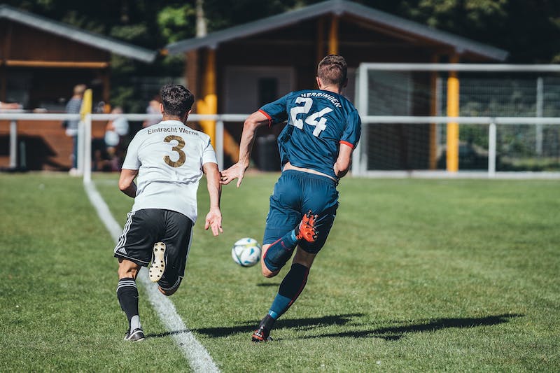 Soccer player doing running endurance training with strength and conditioning drills for improved stamina.