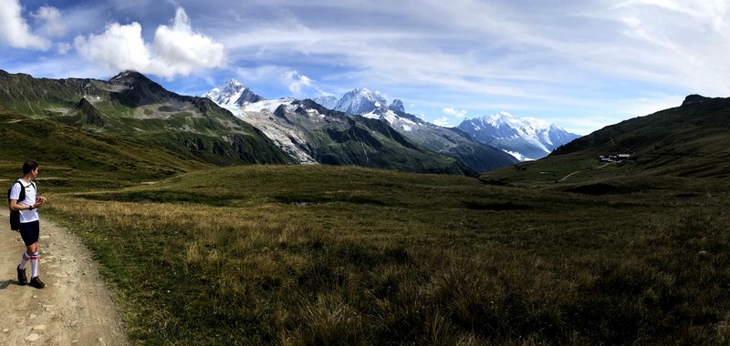 Trail runner hiking the Tour du Mont Blanc route with alpine peaks, ultimate TMB guide.