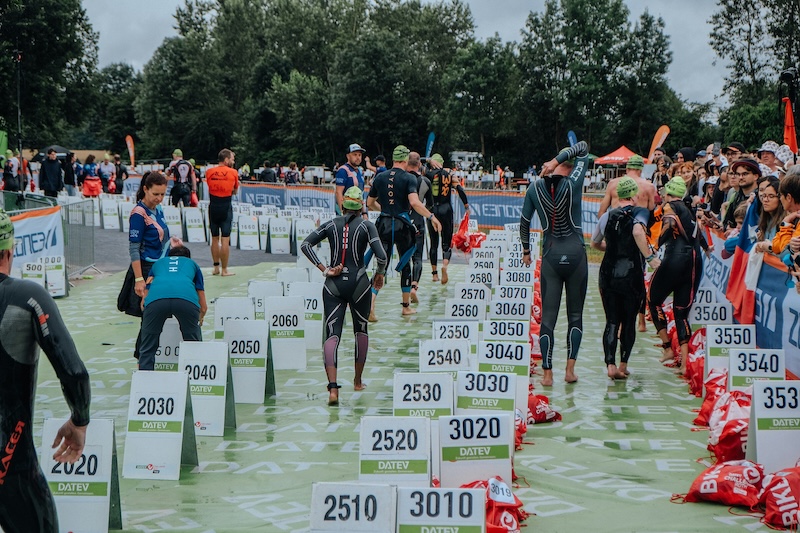Triathlete practicing T1 and T2 transitions with bike and running shoes for faster race times.
