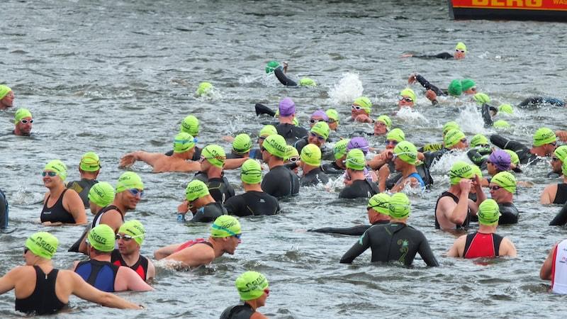 Triathlete reviewing training schedule to identify weaknesses across swim, bike, and run sessions.