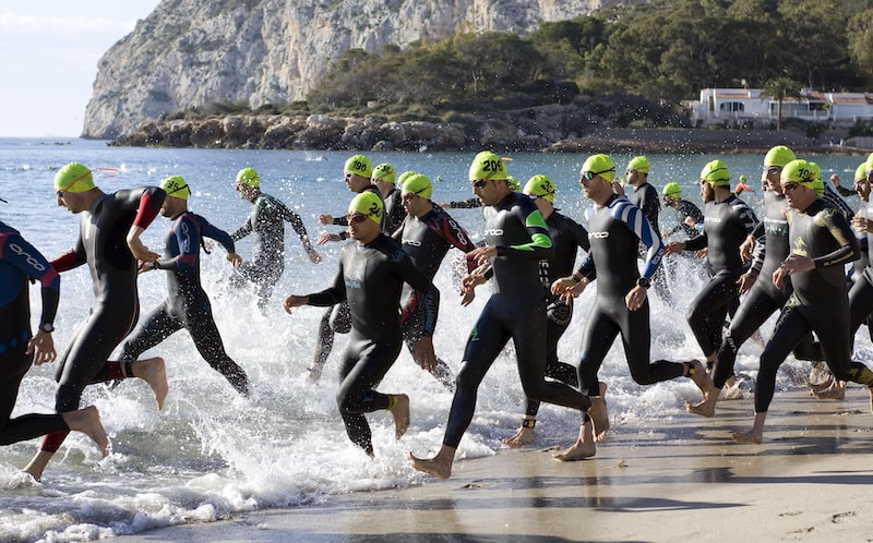 Triathlon training schedule showing intensity sessions balancing swim, bike, and run workouts each week.
