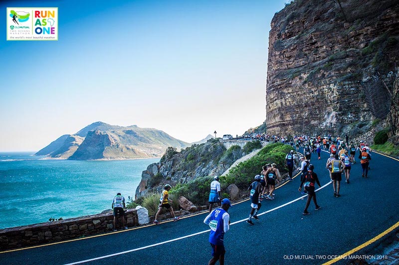 Runner on South Africa coastline during the Two Oceans Marathon, an unusual bucket-list marathon race.