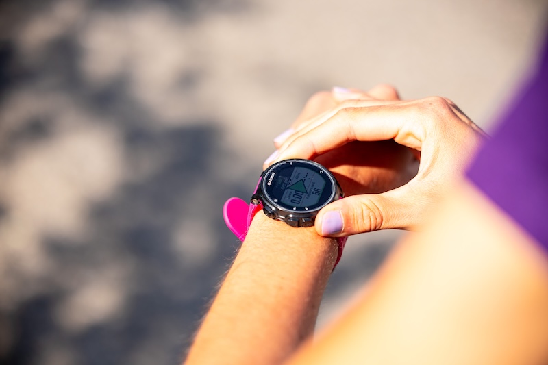 Runner checking a GPS watch while training for a first 10K race