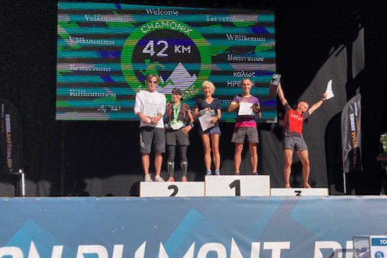 Majida celebrates winning her age group at the Marathon du Mont-Blanc trail running race.