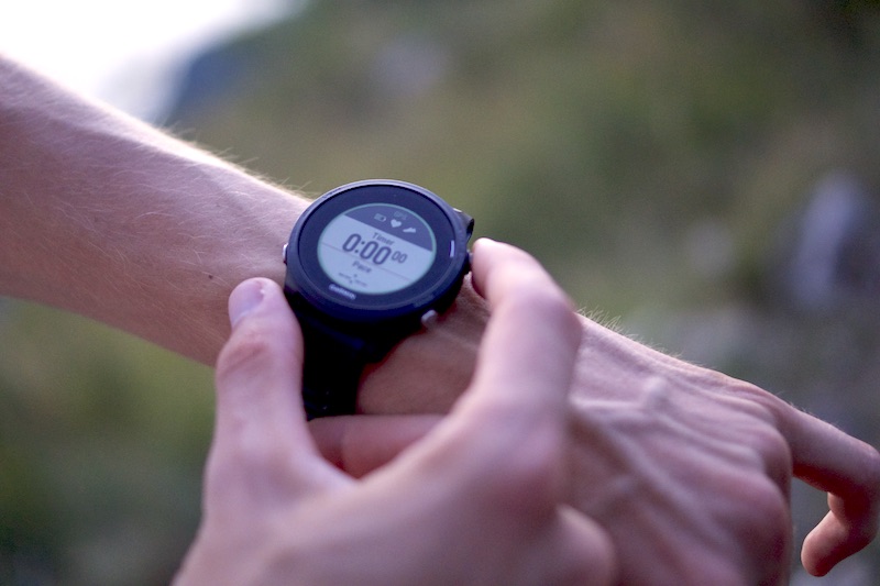 Runner checking smartwatch for resting heart rate and HRV during daily endurance fitness recovery monitoring