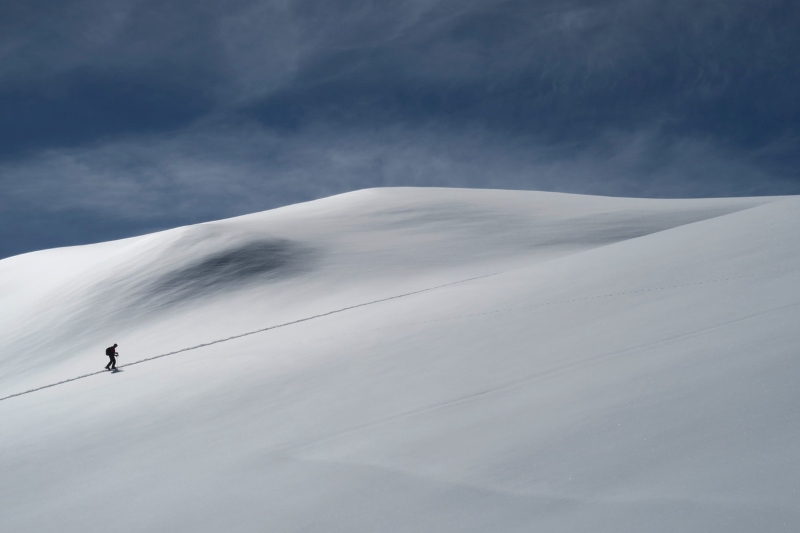 Touring skis and boots for winter ski touring to support trail running endurance training.