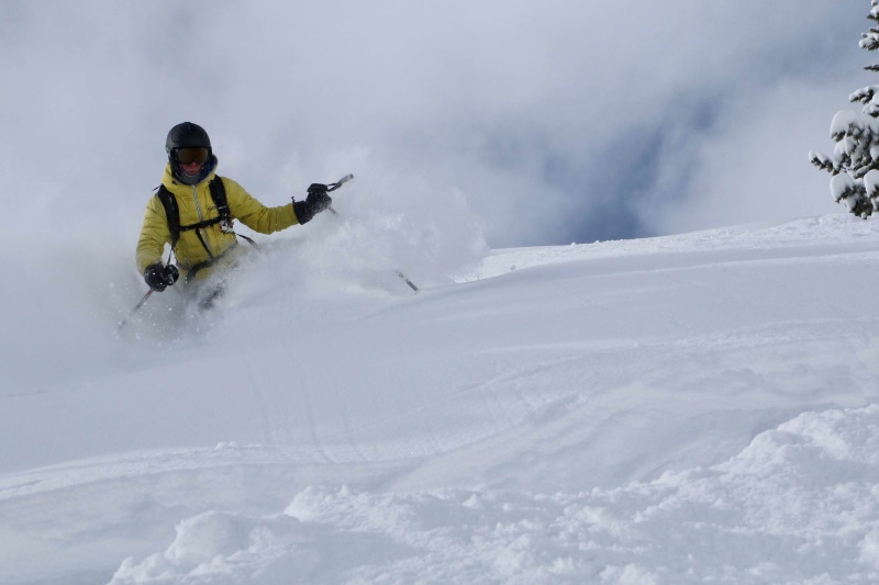 Trail runner ski touring uphill through snowy mountains for effective winter endurance training.