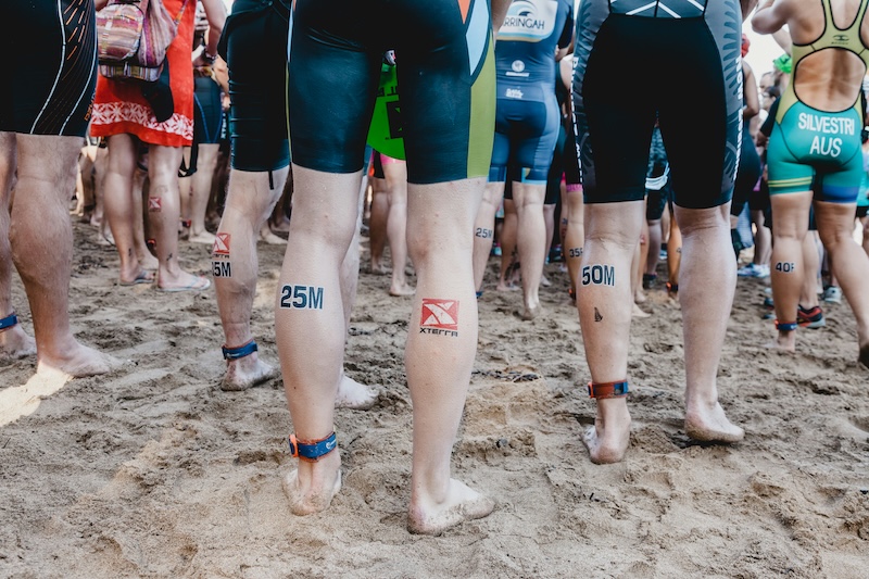 Triathlete structuring a season training plan for swimming, cycling, running, and race preparation