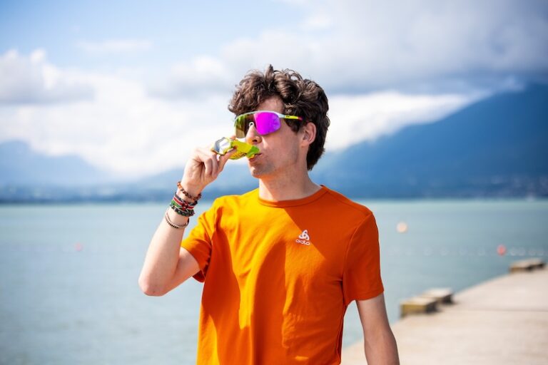 Runner taking an energy gel by the lake