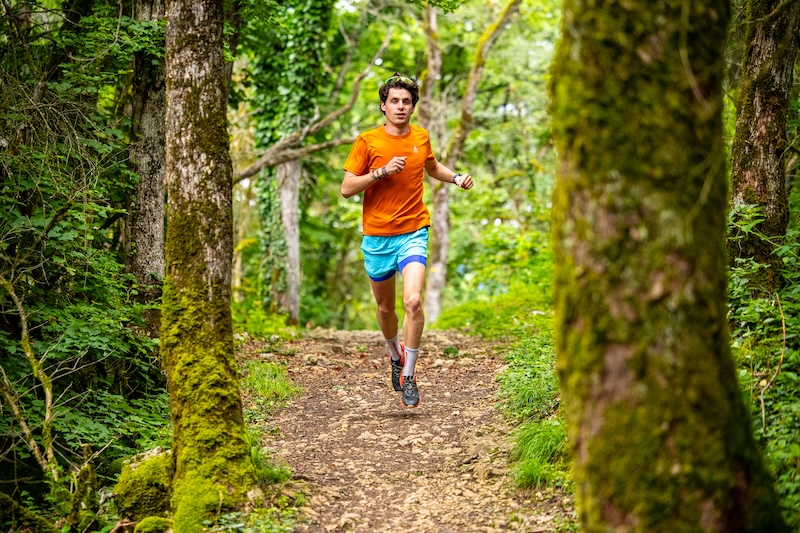 Trail runner training for a Backyard Ultra endurance race on a forest loop