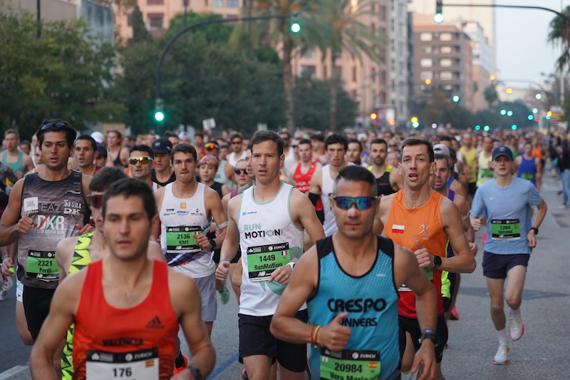 Runner racing the Valencia Marathon, a fast course designed for achieving a personal best.